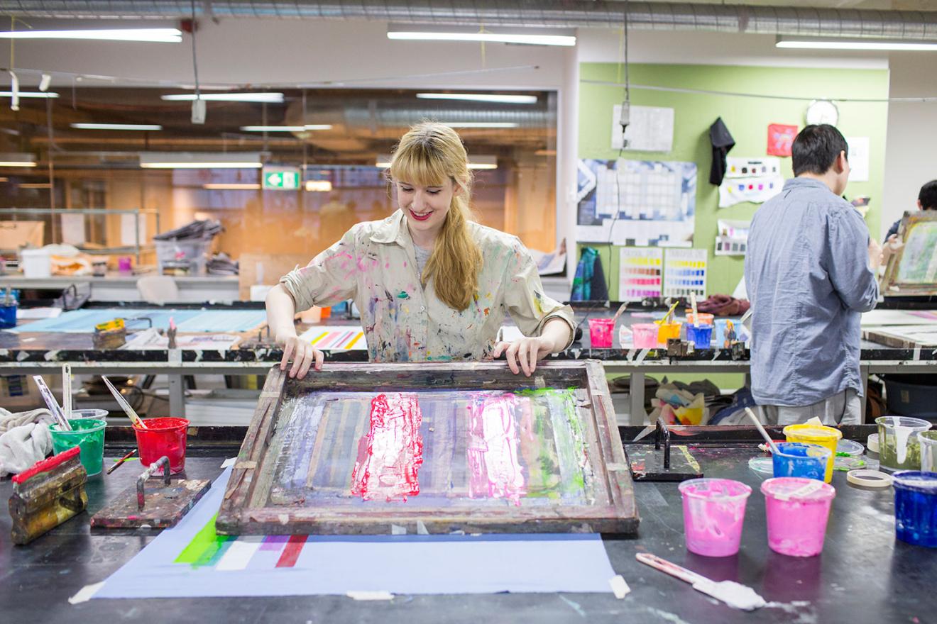 student screen printing in textiles workshop