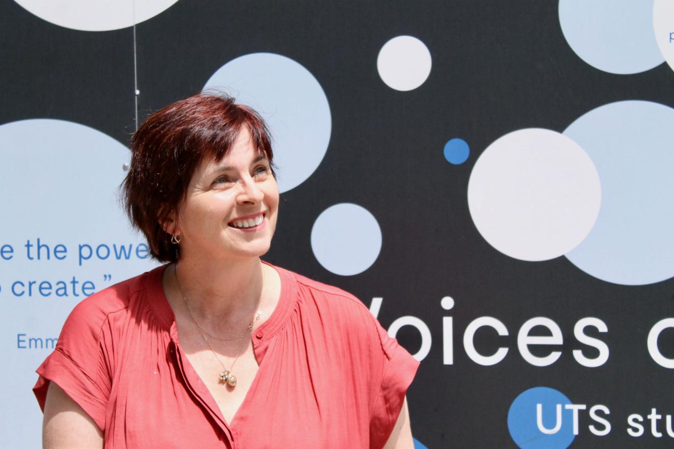 Bronwyn Hemsley smiling in front of UTS sign