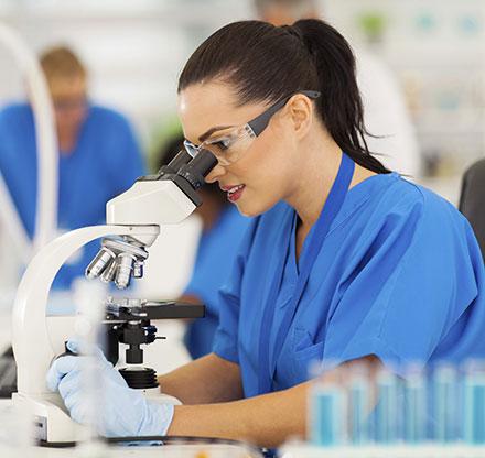 Girl looking into microscope