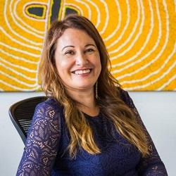 Photo of Distinguished Professor Larissa Behrendt, seated and smiling at camera