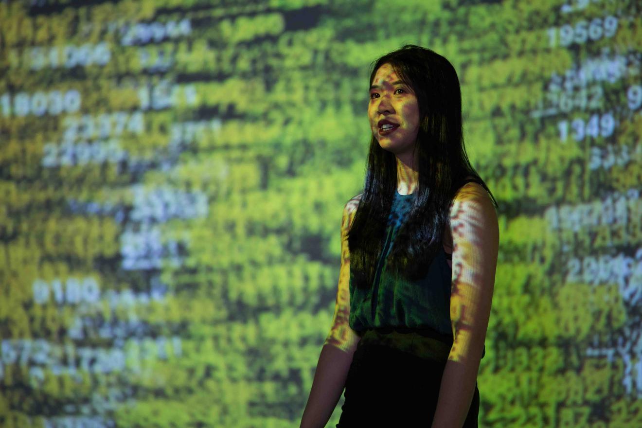 A math student presenting in front of a projection
