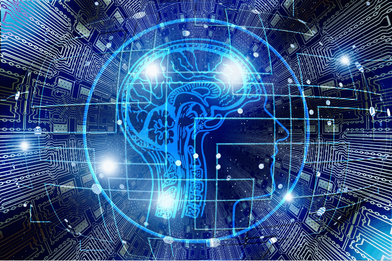 circuits with an abstract overlay of a profile with brain to represent machine learning or artificial intelligence