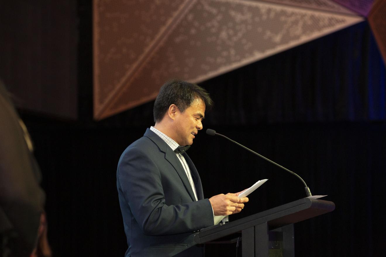 Man in suit presenting vice chancellors awards