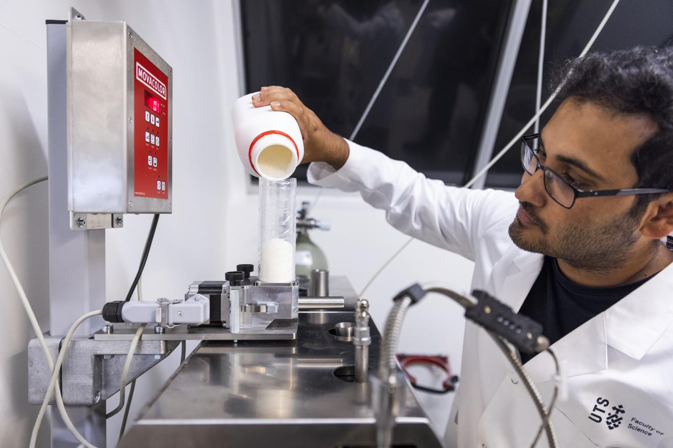 Scientist pouring Powder into a funnel
