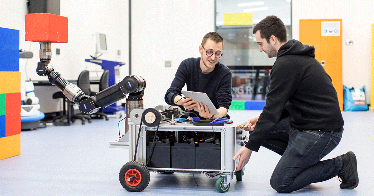 HDR students in lab with robot