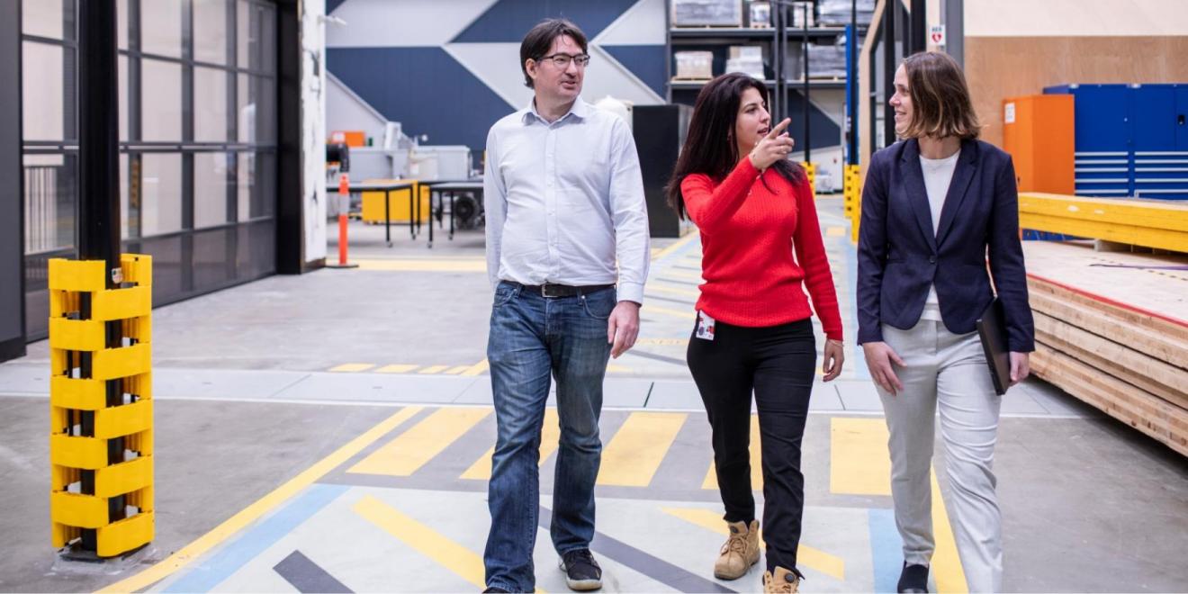 A man and two women walking through the UTS Tech Lab facilities