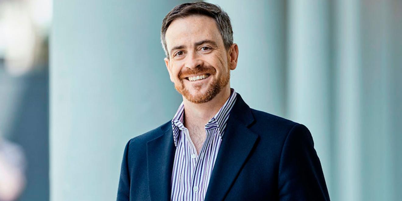Man in a suit smiling and looking at the camera