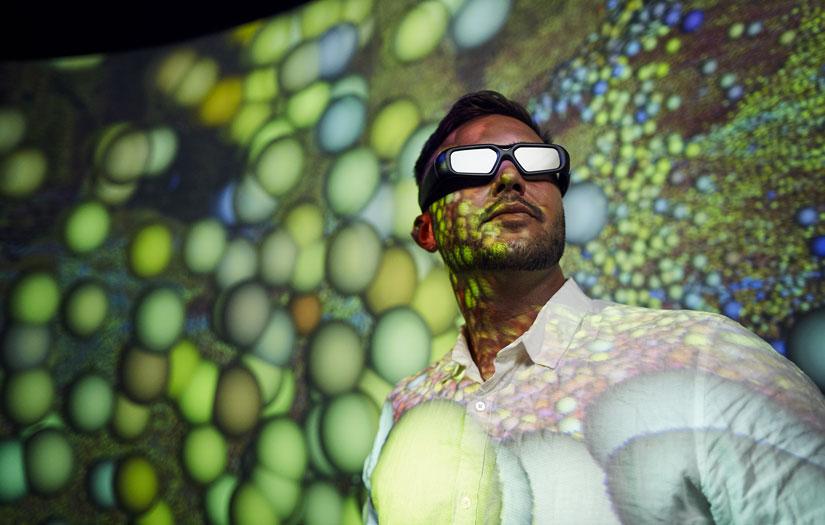 Young man wearing 3D glasses in the data arena