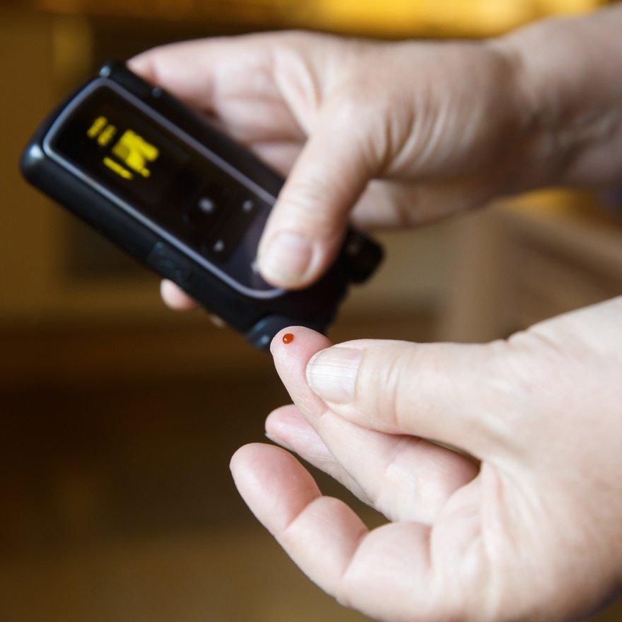 Diabetic patient testing blood for sugar level