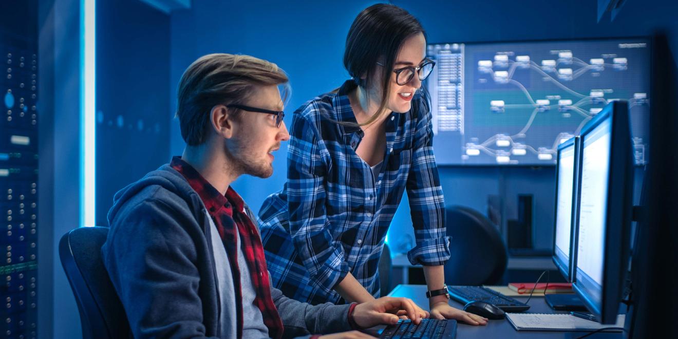 Two students looking at a computer screen