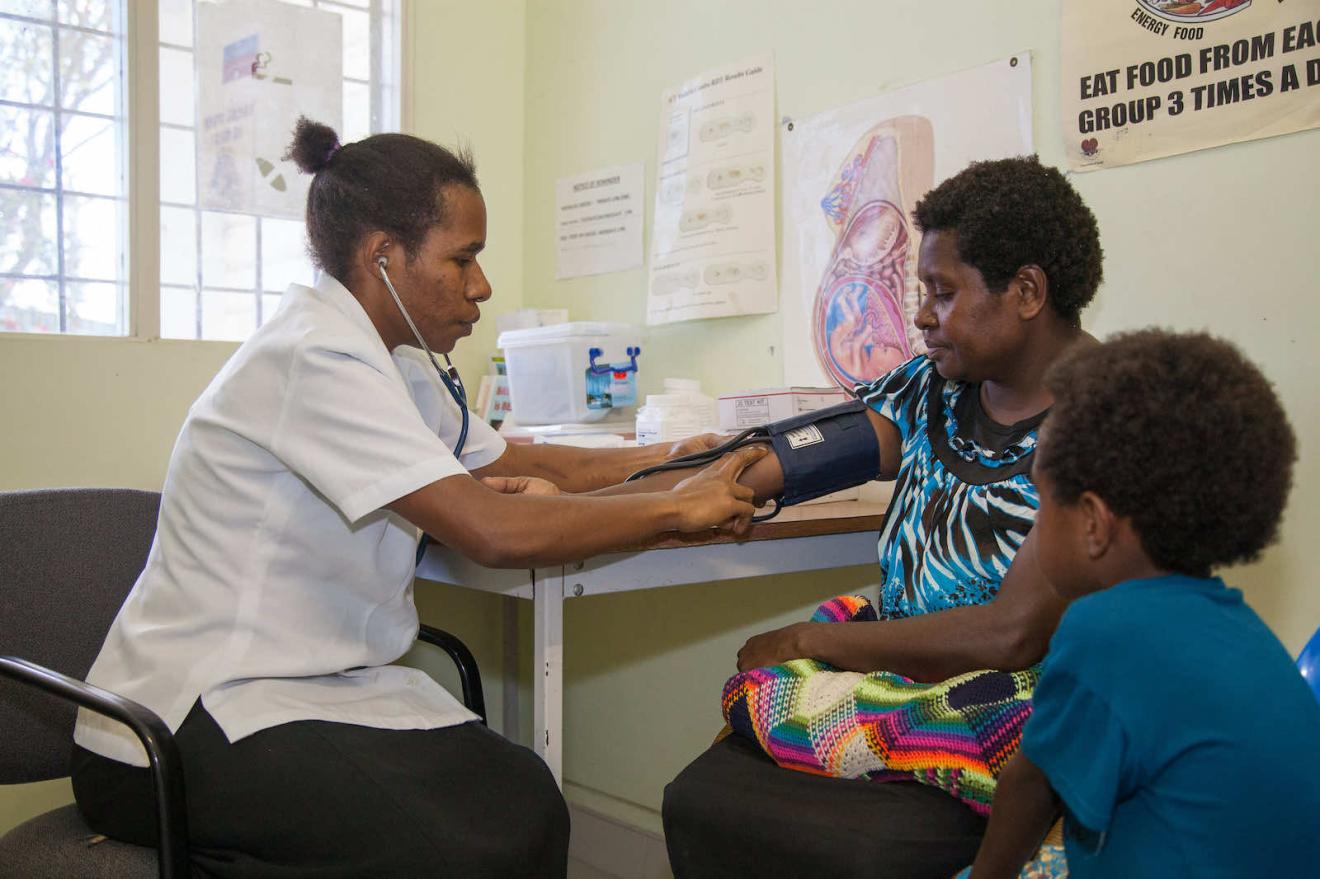 A nurse testing a patient's blood pressure