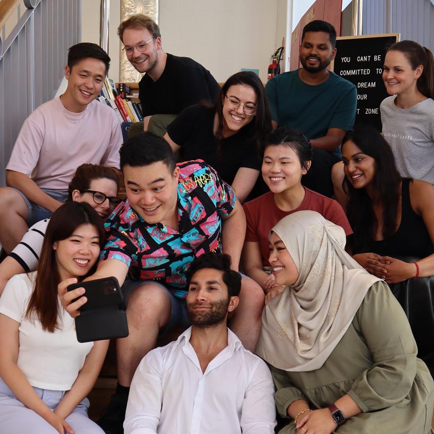 Group shot of young alumni taking a selfie