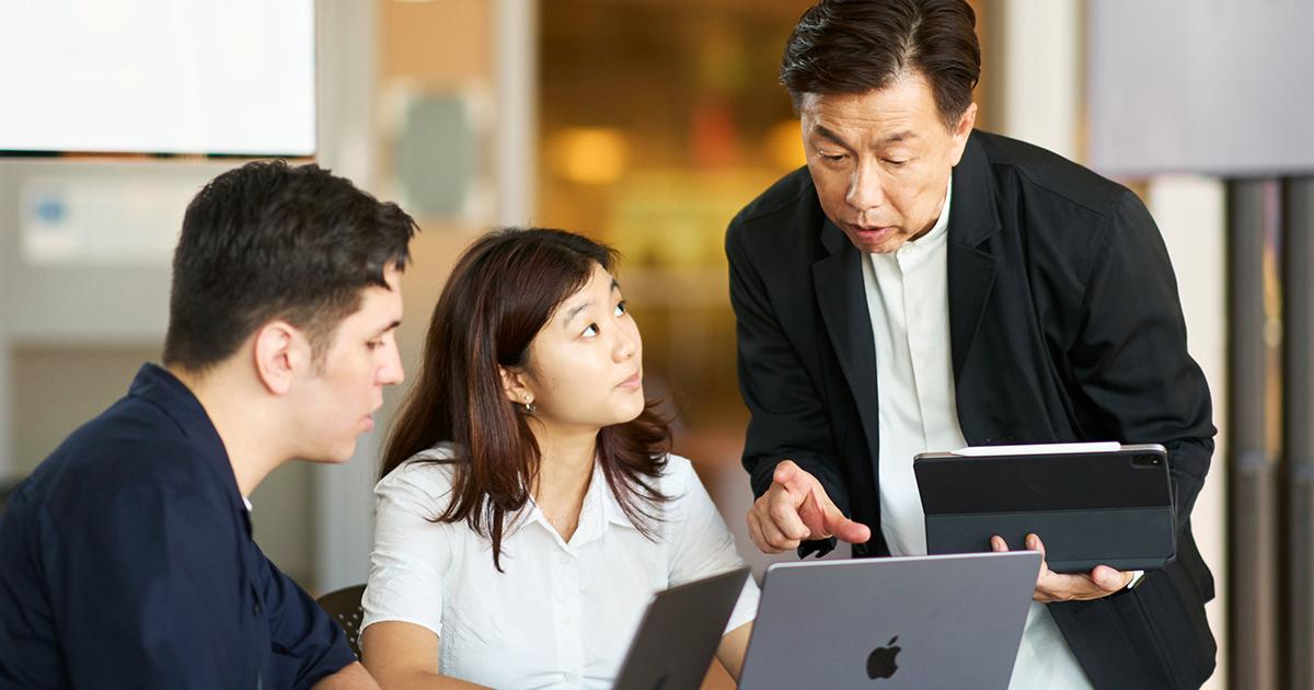 Two students listening to their mentor