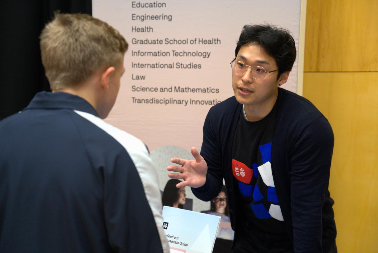 Student Ambassador talking to a student at a Career Market