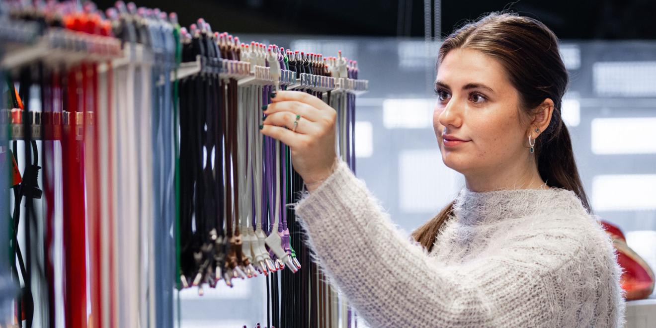 Young woman inspecting electrical wires