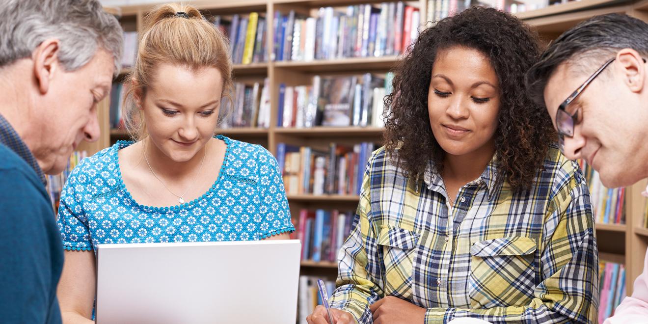 Research students studying in a library