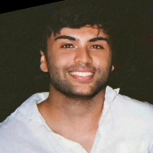 Man with dark hear, wearing white shirt