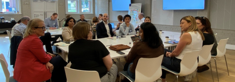 People talking around a table at a workshop