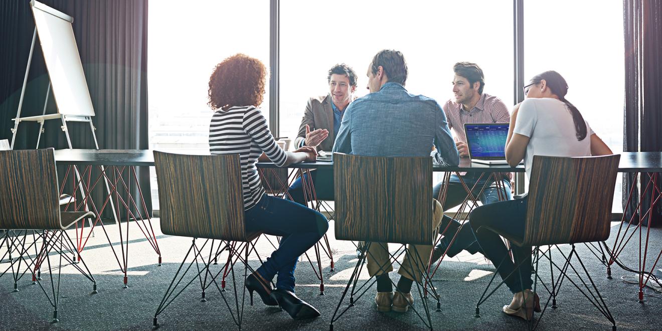 Group of professionals having a meeting a well-lit room.