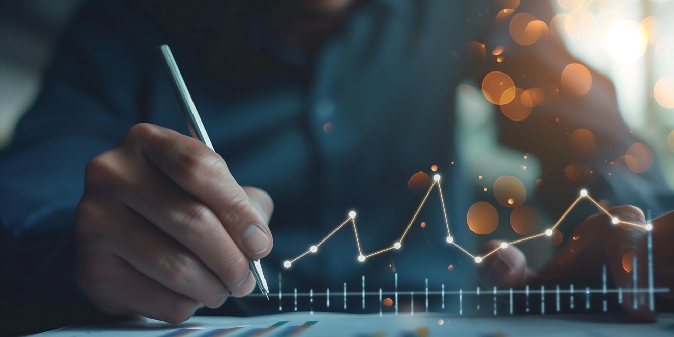 Man working on a data document with abstract graphs in the foreground