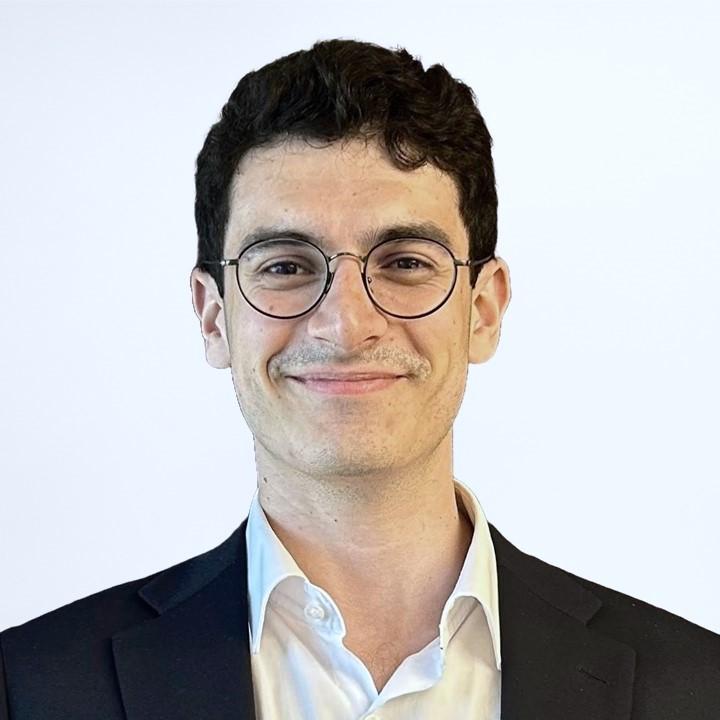Man with dark hair and glasses