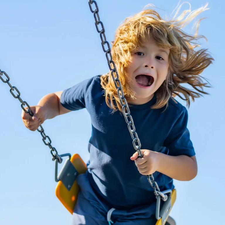 Child in motion on a playground swing