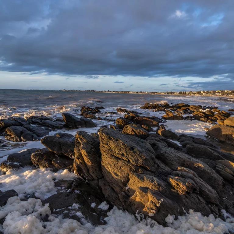 Foam on rocky sea shore