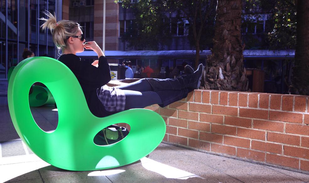 Staff member outside on green chair