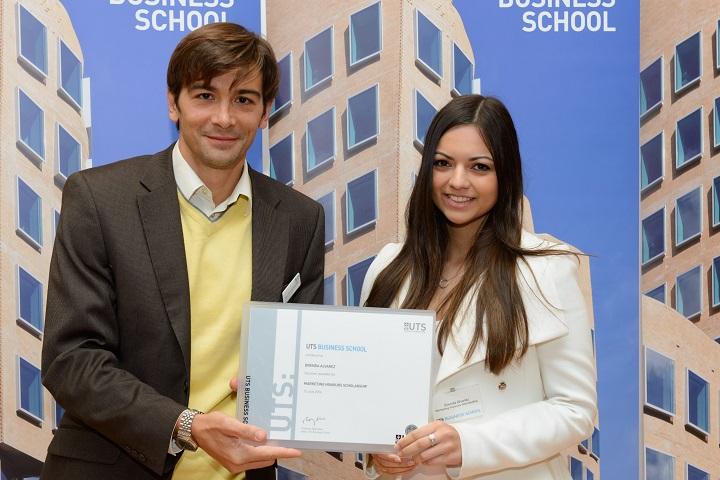 Honours student Brenda Alvarez receives her Honours scholarship certificate from the Marketing Deputy Head (Research) Associate Professor Francois Carrillat