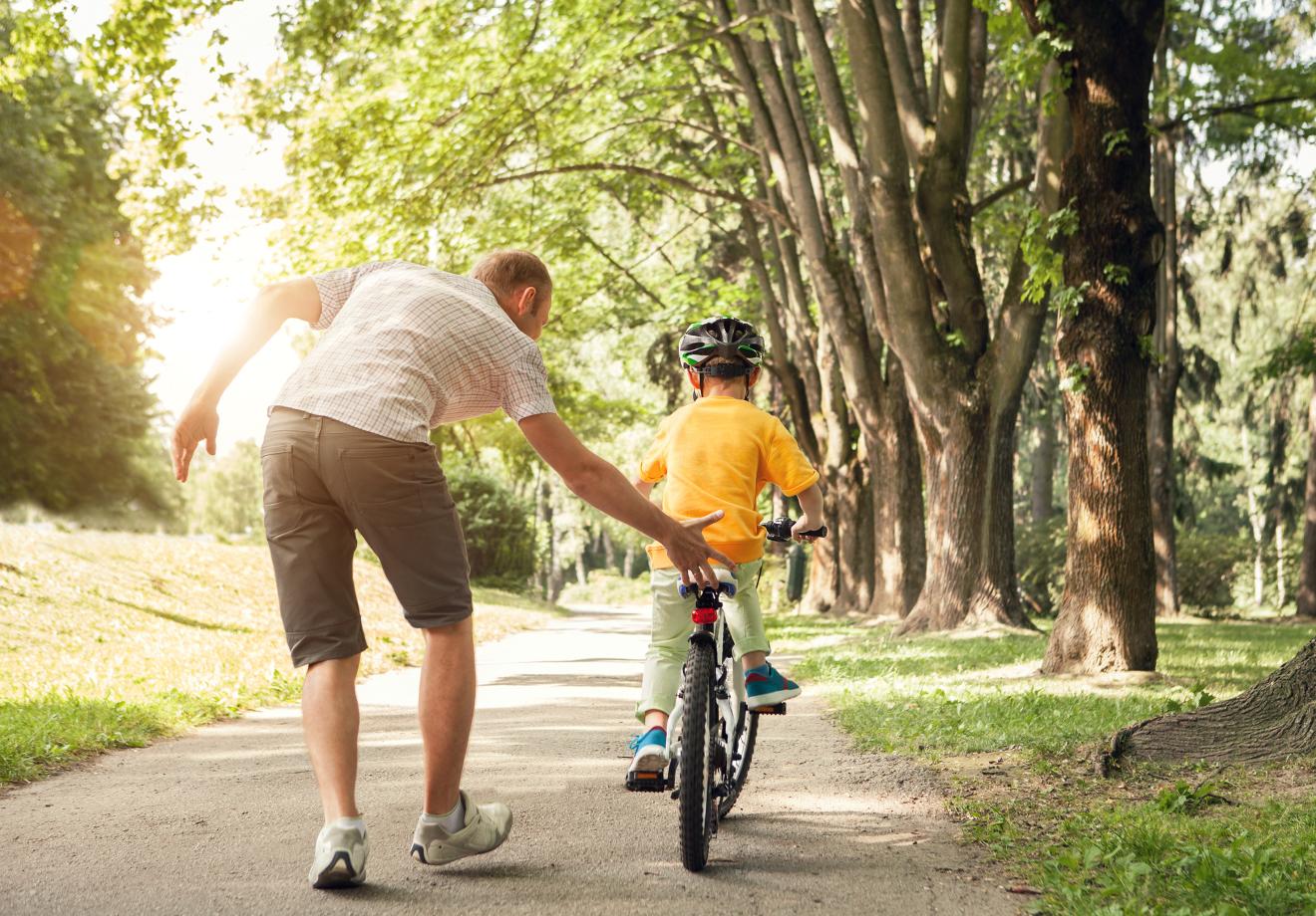 Dad and son on bike