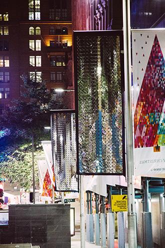 Lights shining on a banner’s moving surface produce dynamic light formations on Martin Place's surfaces