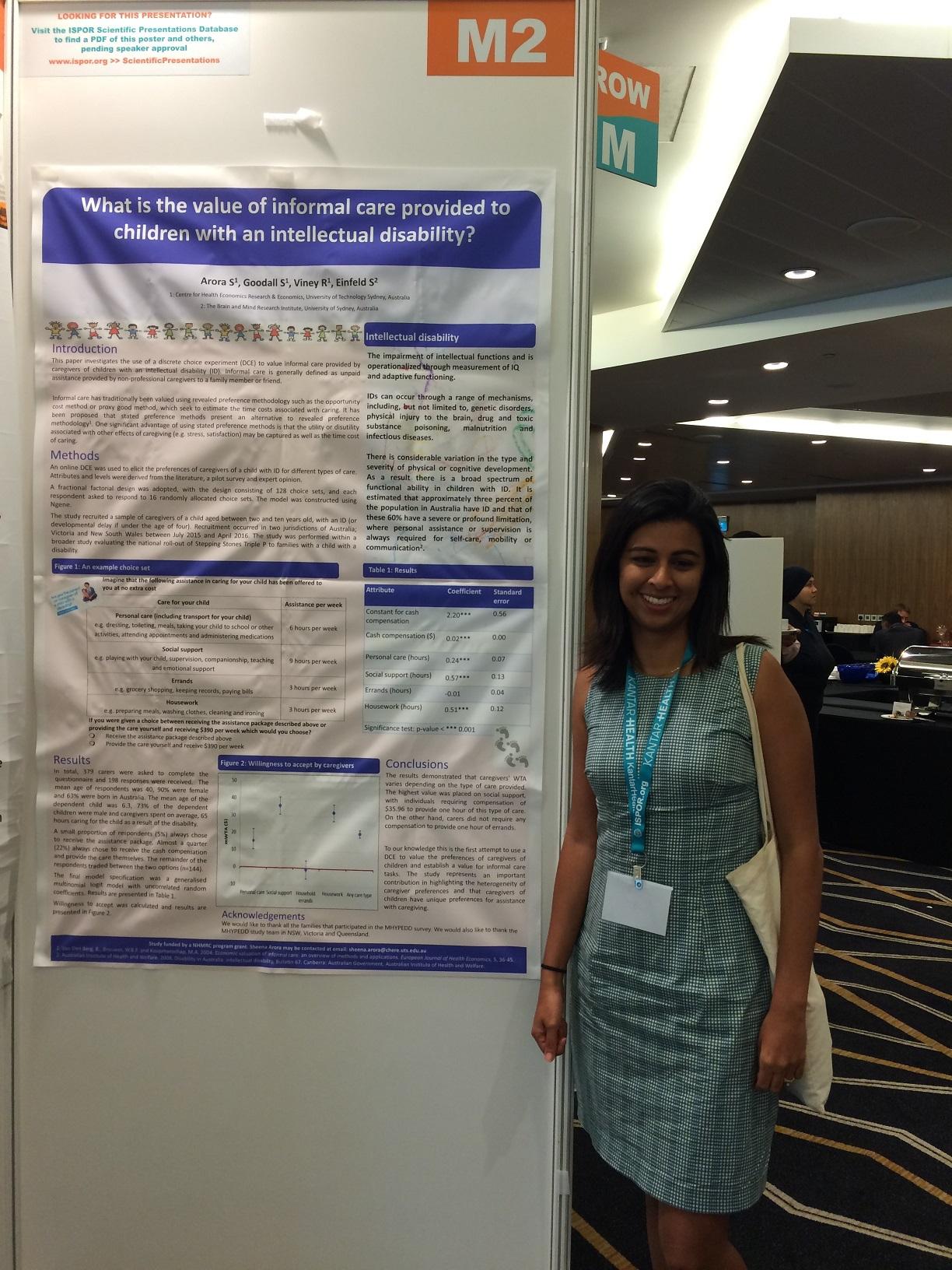 Sheena Arora standing beside her poster 