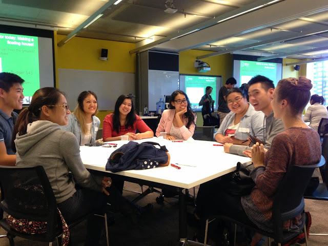 Group of volunteers sitting around a table smiling 