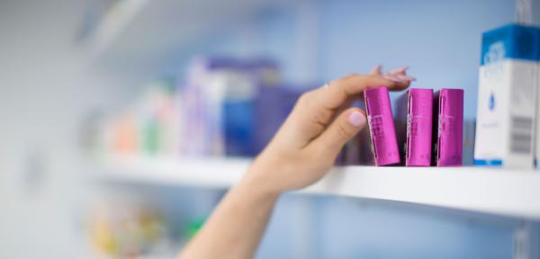 GSH Pharmacy banner.  Close up of hand reaching for medication in pharmacy.