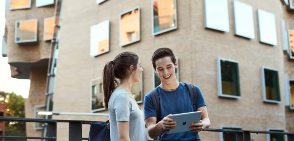 Two students in front of the Dr Chau Chak Wing Building, home of UTS Business School