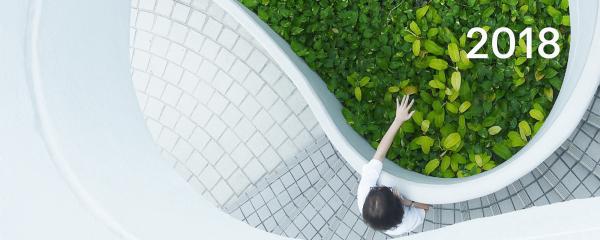 person touching greenery with words 2018