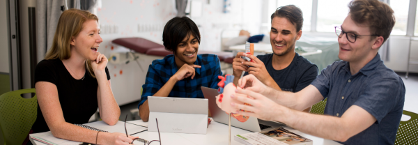 UTS students in a classroom with an anatomical heart model