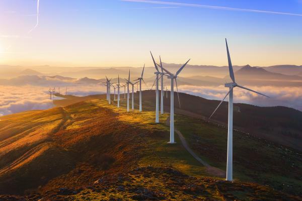 Wind farm on top of a hill at sunset