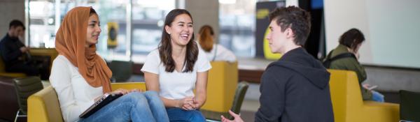 Three IT students in discussion