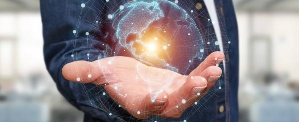 A hand holding the globe