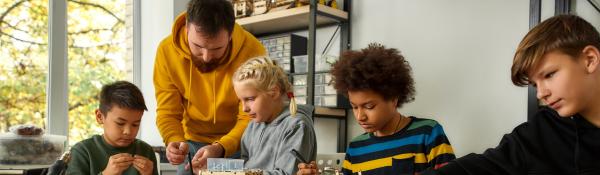 Classroom setting. Teacher, young children.