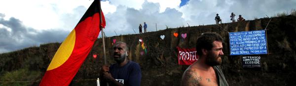 Protestors, placards, aboriginal flag