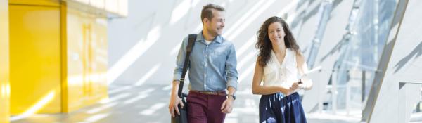 Two postgraduate students walking and talking