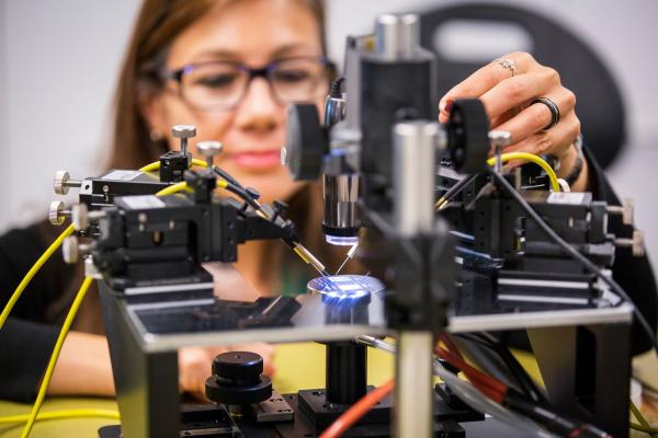 Woman wearing glasses works with lab equipment