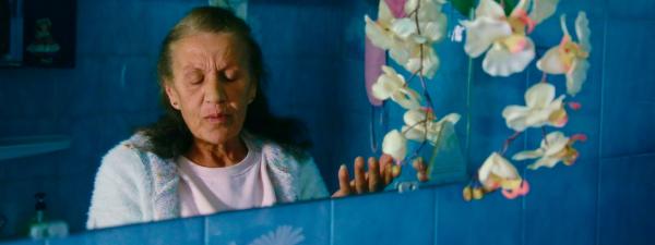 An older woman's face reflected in a mirror 