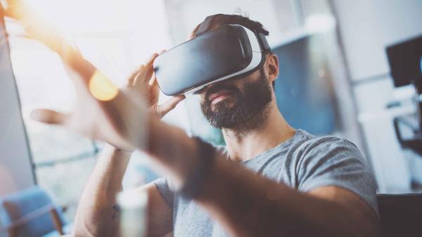 Close up of young man wearing a virtual reality head set.