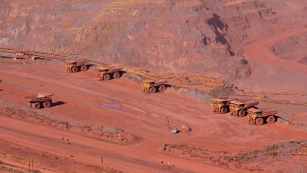 Large, open-pit iron ore mine with trucks