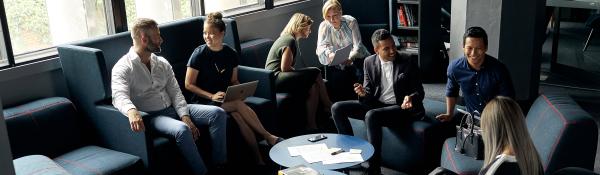 People seated and talking in small groups