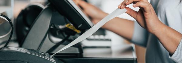 Women pulling a receipt out of a machine