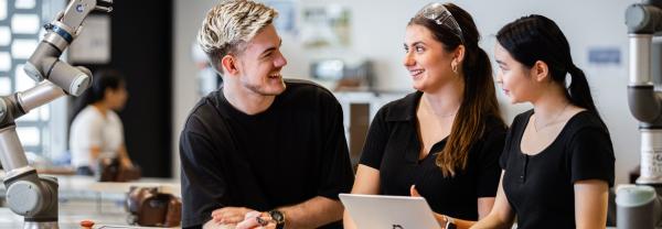 Three students collaborating in an engineering lab at UTS